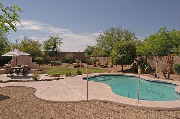 Gorgeous 1/4 Acre lot with Pool and Grassy Play. Covered patio, fireplace!