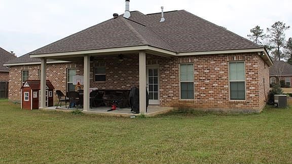 VIEW OF THE BACK OF 41235 COVEY RUN WITH A LARGE COVERED PATIO AND NICE BACKYARD
