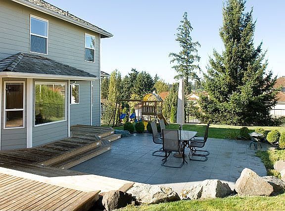 Sunken stone deck with extensive landscaping & sprinkler system