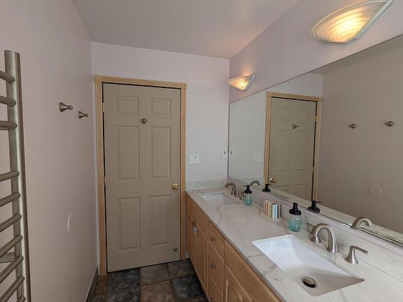 bathroom with double sink and quartz tops