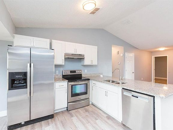 Our kitchen features a dining area and modern appliances, perfect for preparing and enjoying home-cooked meals.