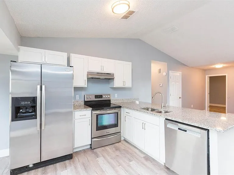 Our kitchen features a dining area and modern appliances, perfect for preparing and enjoying home-cooked meals.