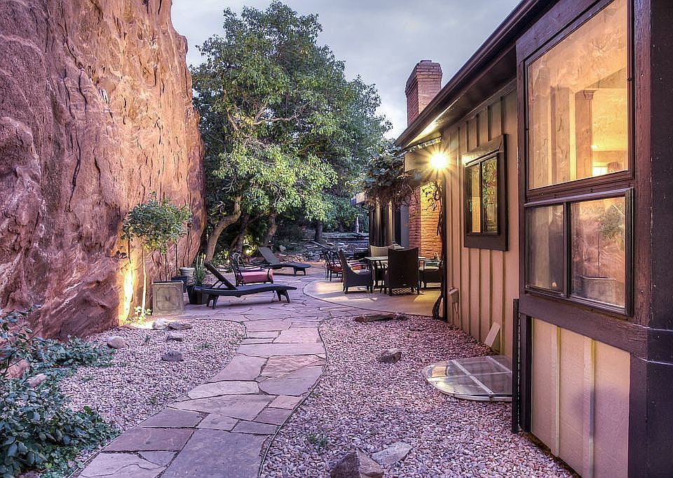 Spacious rear patio with red rock!