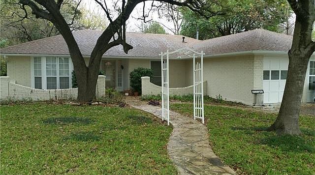 Fresh exterior paint and new gutters on a quiet tree lined s