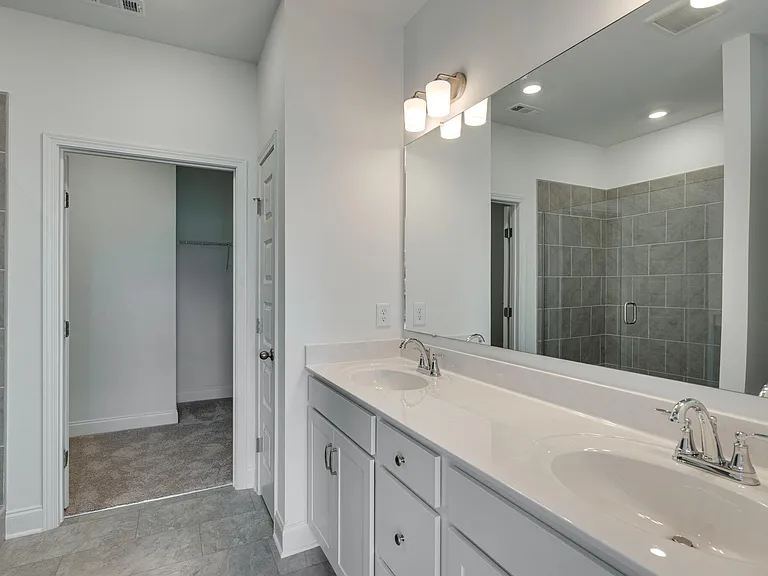 Main BR bath with double vanities, walk in shower and huge walk in closet