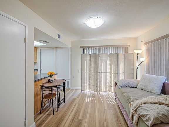 Dining area currently set up with a daybed has plenty of space for a full-size table.