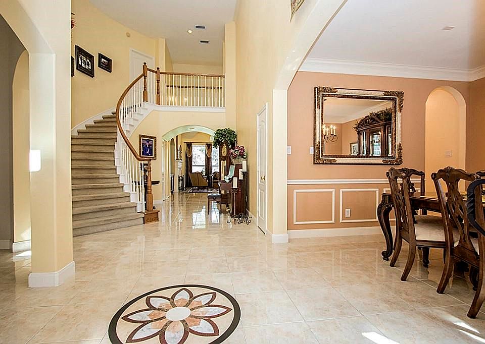As You Walk In This Beautiful Home You Will Immediately Notice The Beautiful Marble Floors With An A Unique Custom Inlay Design In The Foyer. The Winding Staircase That You Will Lead You To The Split Plan Bedrooms And Game Room Upstairs.