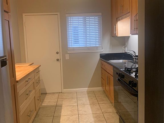 Kitchen with 2nd entry door leading out to the back yard / laundry room via stairs.