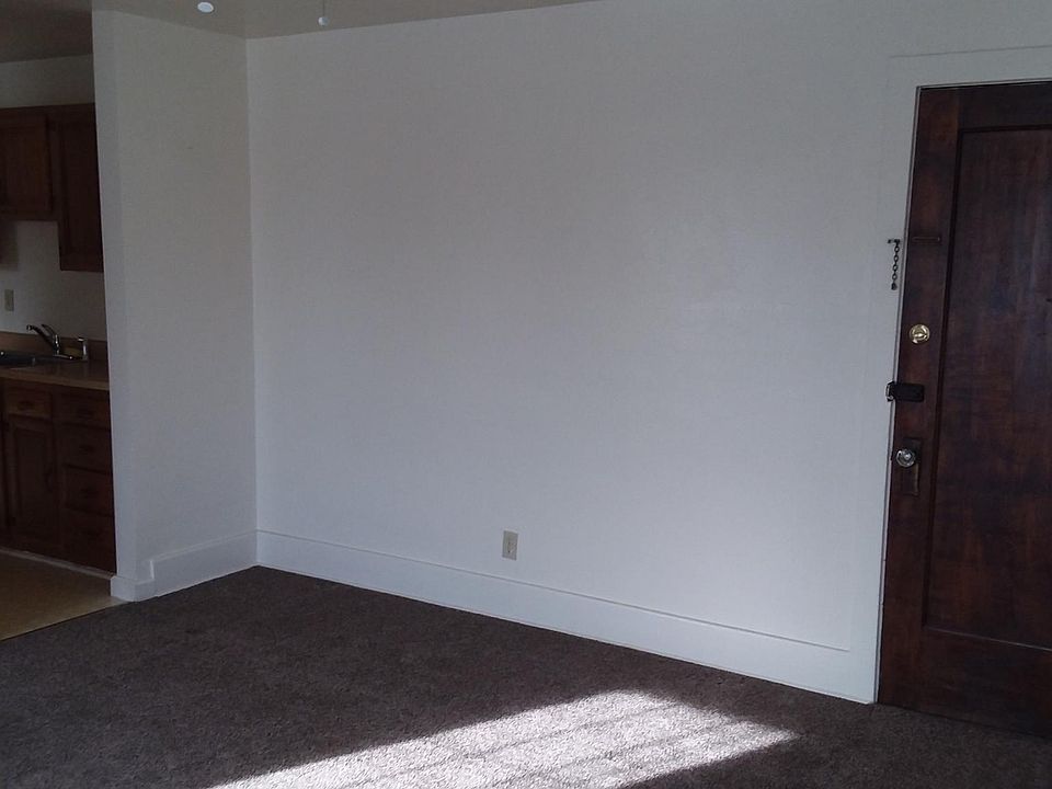 Living room with view of kitchen and front access door
