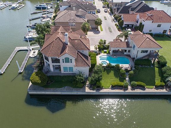 REAR AERIAL VIEW OF THIS INCREDIBLE ESTATE AT THE POINT IN WATERFORD HARBOR HIGHLIGHTS THE WRAPAROUND VIEWS SPANNING 250'+ OF WATERFRONTAGE. THE COMPOUND BOATS A MAIN HOUSE WITH 60' DOCKING FOR YACHTS, OUTDOOR LIVING SPACE WITH POOL AND OUTDOOR KITCH