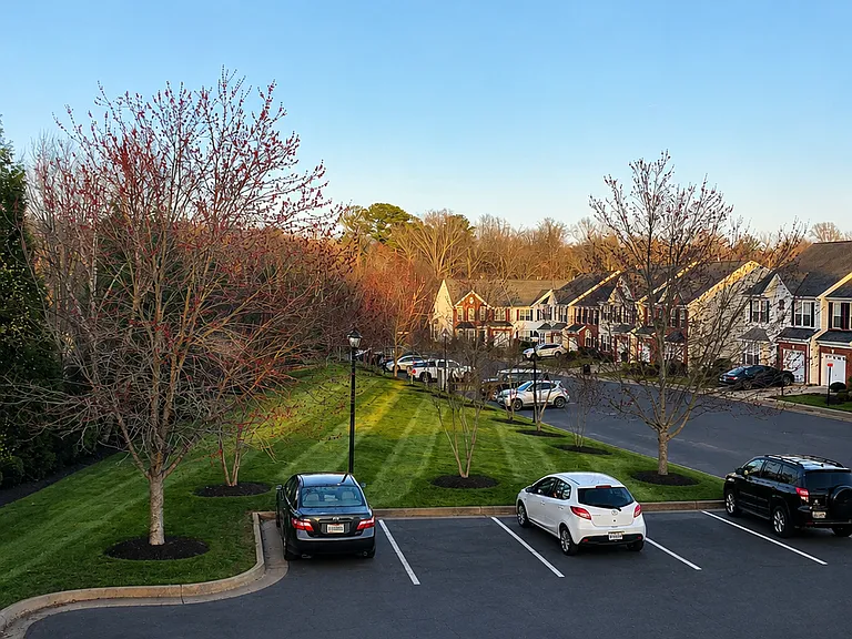View of other houses and parking(left two) in community from bedroom window.