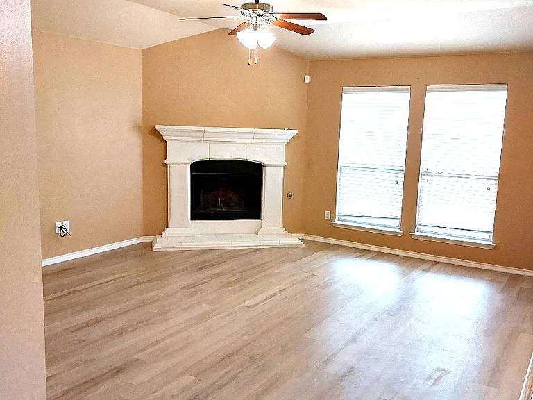 Large family room with beautiful NEW UPDATED FLOORING & Beautiful fireplace. SUPER CLEAN and well maintained HOME!