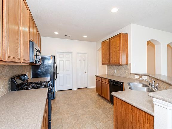 Corian counters and lots of cabinets in this kitchen.