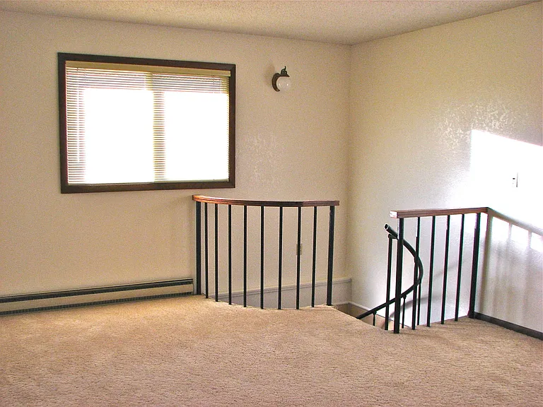 Upstairs living room with stairs leading to lower level