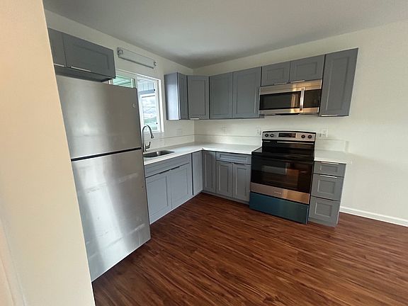 Full kitchen with refrigerator and stove