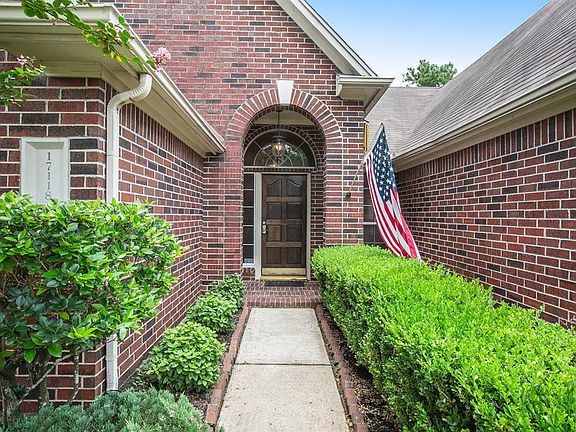 Lush landscaping leads down the brick lined sidewalk up to an arched front porch! A brick exterior is so timeless and almost maintenance free!