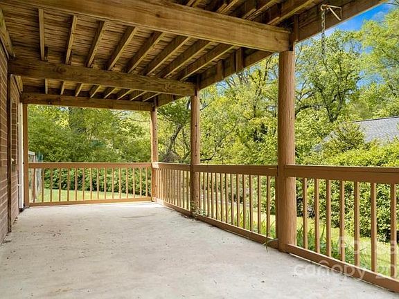 Covered porch with plenty of backyard greenery to enjoy