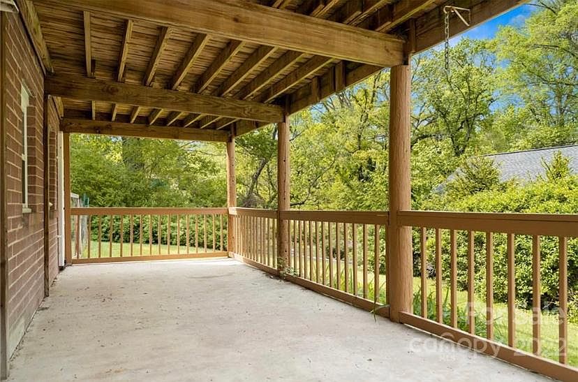 Covered porch with plenty of backyard greenery to enjoy