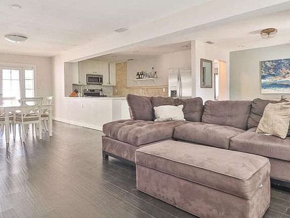 Open concept living room, dining room and kitchen with bamboo floors