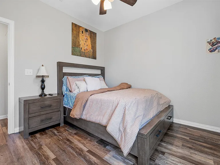 Wood-finish flooring throughout, featuring a neutral wall color and white trim