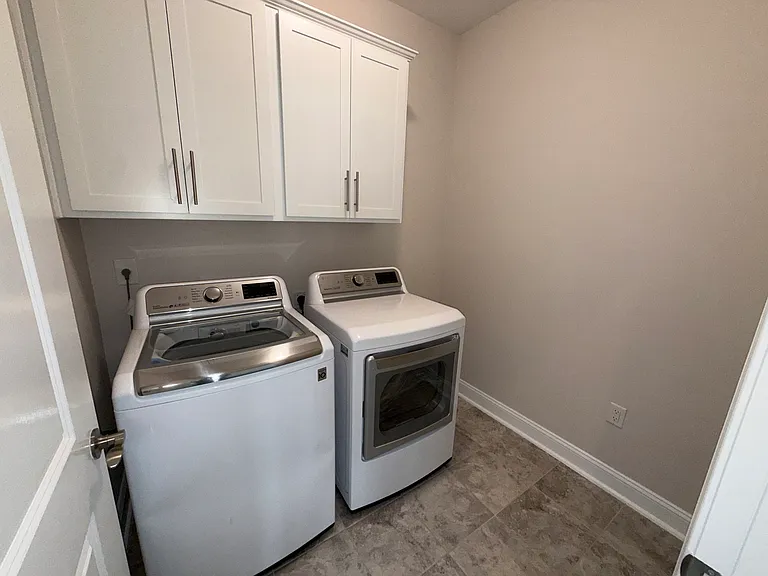 Laundry with Ceramic Floor and Built In Cabinetry. Upgraded LG washer and dryer