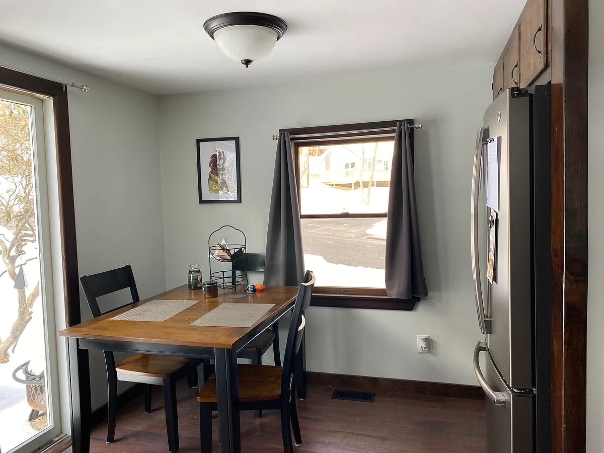Kitchen side with fridge, space of dinner table with sliding glass door to outdoor concrete patio space - 7 Ola Ave