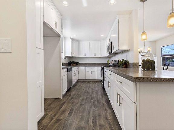New custom kitchen with beautiful quartz counter tops, new floors & stainless steel appliances.