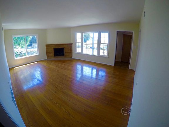 Formal living room with hardwood floors, stone fireplace and