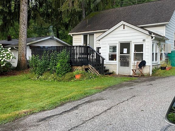 Back of house with small sunroom add on/ entry and deck