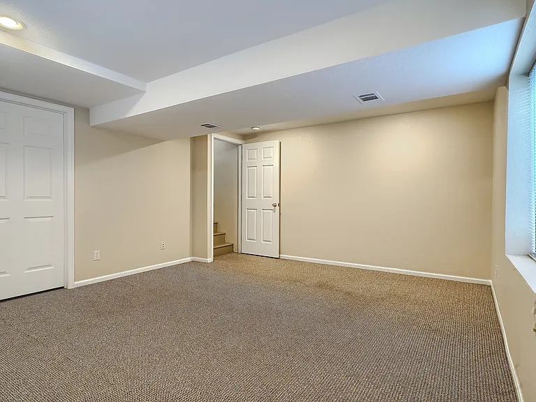 Basement rec room with egress windows (often used as a bedroom)