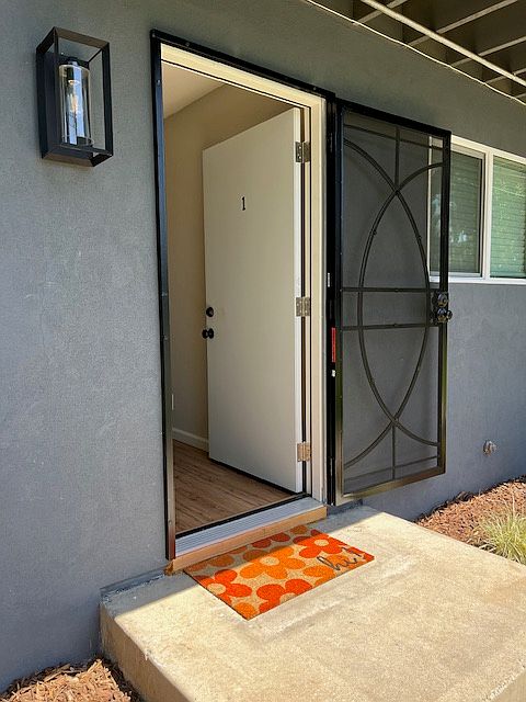 Enter into the unit with new front door and security door. Exterior was recently updated with new stucco siding, new lighting and all new dual pane windows.