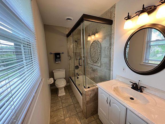 Custom inlaid tile & glass enclosed shower