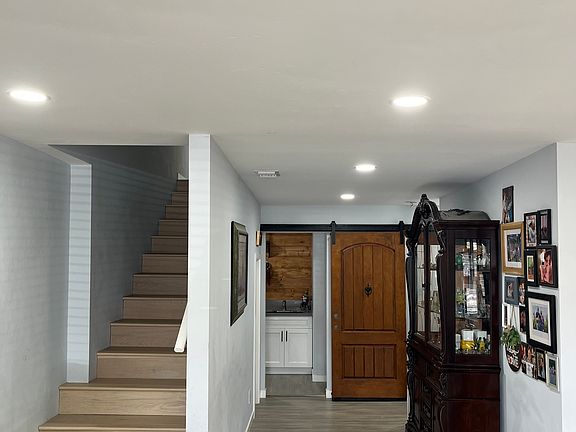 Stairs to master bedroom and hallway to sunroom.