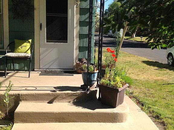 Front door and side yard at street