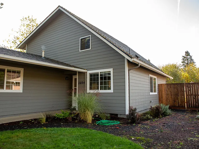 West side of the house, with gated entrance to the backyard.