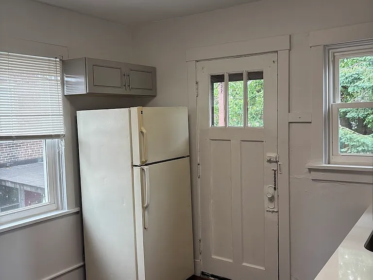 New kitchen with extra storage above the fridge. Rear door leads out to your own outdoor space. Great for summer BBQ's.