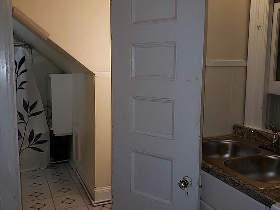 Kitchen leading into bathroom and shower