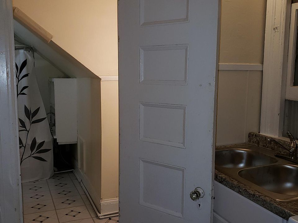 Kitchen leading into bathroom and shower