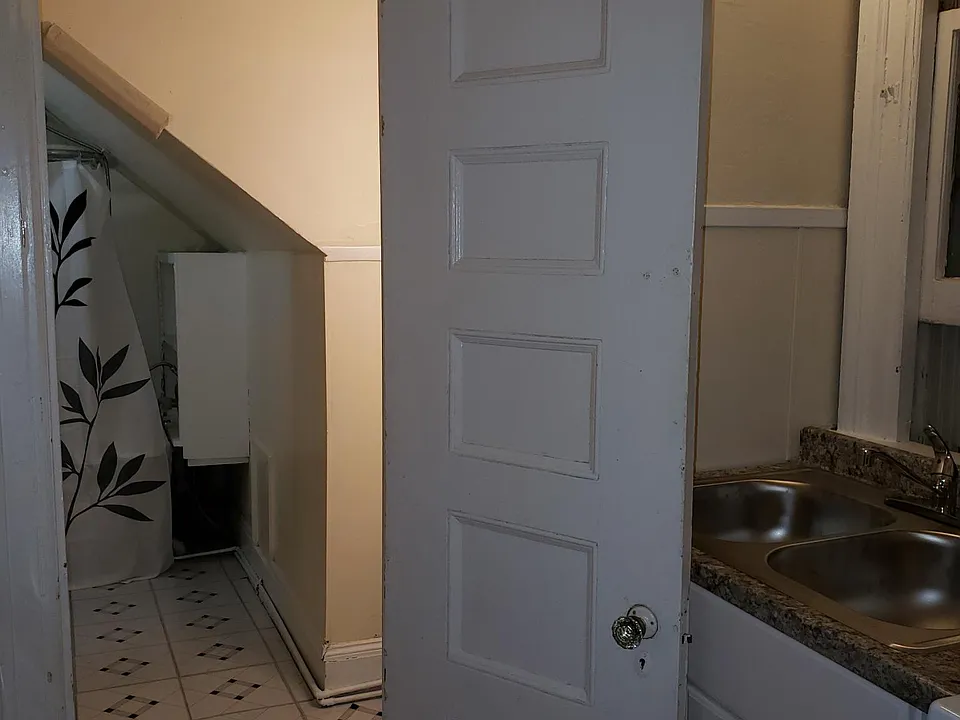 Kitchen leading into bathroom and shower