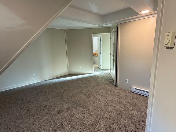 Living room/dining area looking at hallway to bathroom and bedrooms.