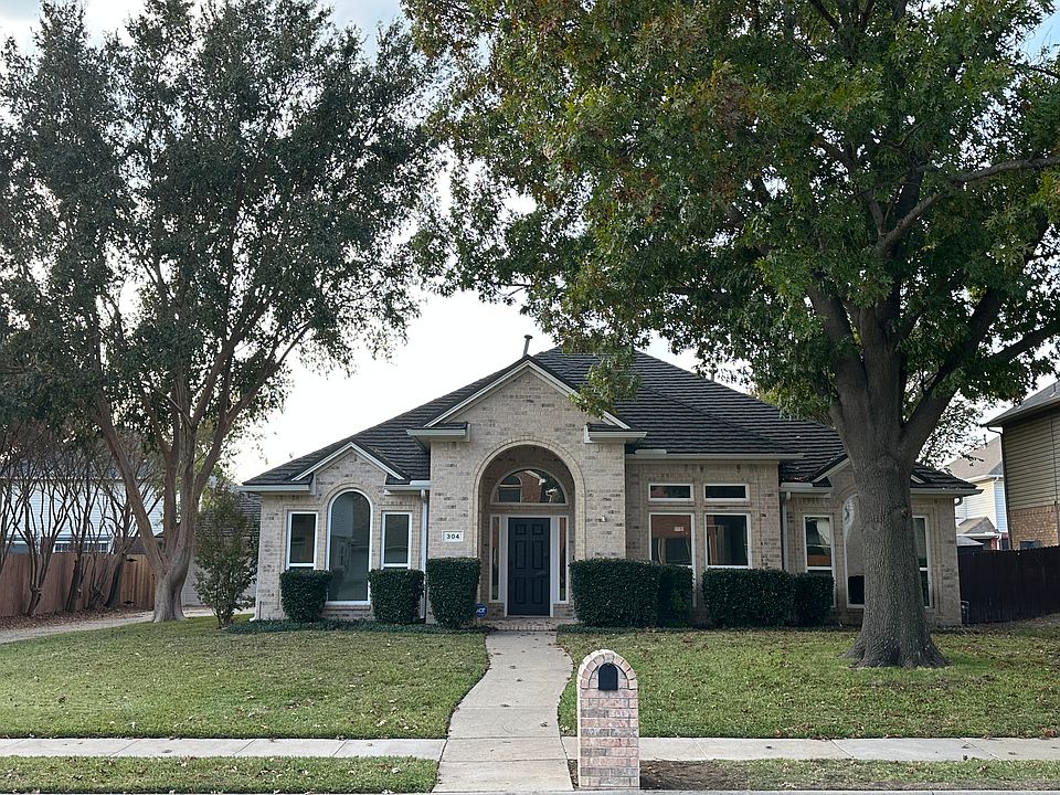 Front of house with mature trees, all new windows.