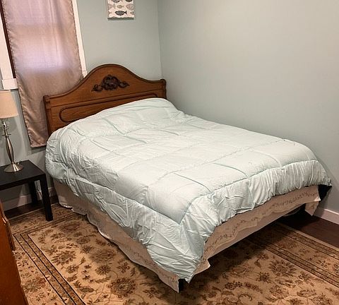 Second bedroom with new walls and floors with a door to the bathroom.