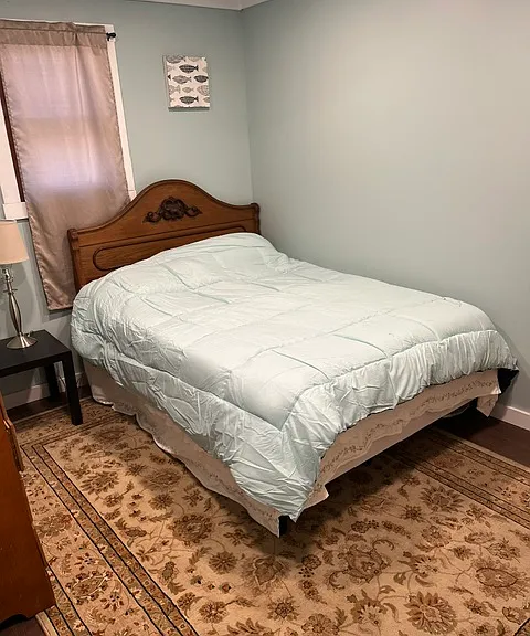 Second bedroom with new walls and floors with a door to the bathroom.