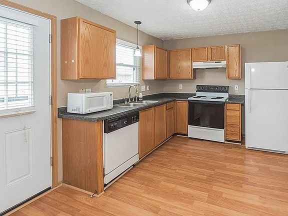 Spacious kitchen with wood cabinets, ample counter space, and natural light.