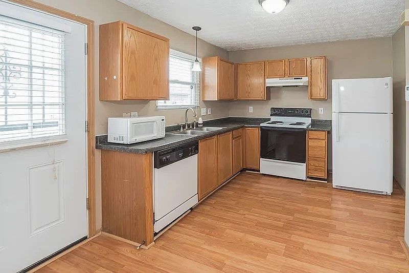 Spacious kitchen with wood cabinets, ample counter space, and natural light.