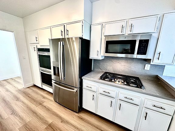 Unit #302 HUGE kitchen with ALL brand-new stainless steel appliances! Double ovens, gas cooktop, microwave, top of the line refrigerator, dishwasher and wine refrigerator!