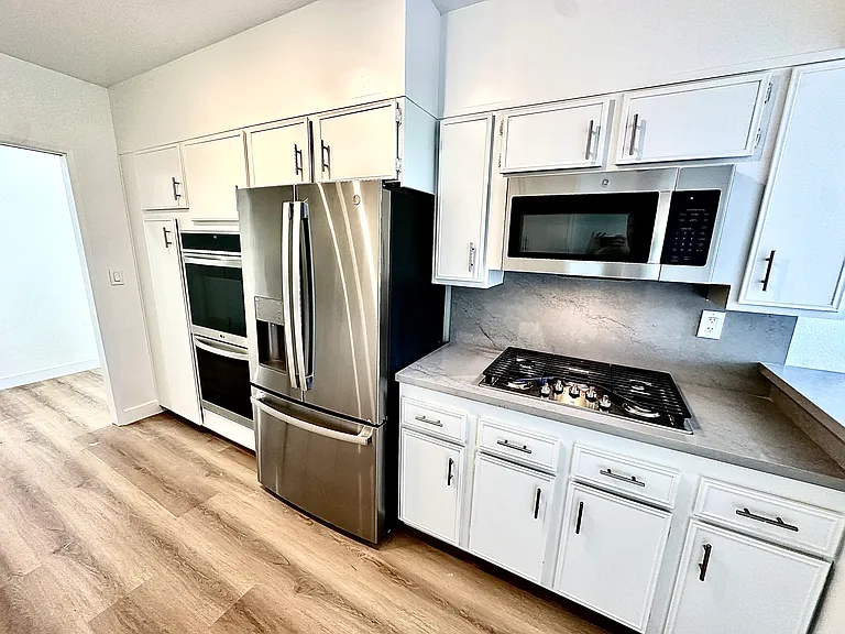 Unit #302 HUGE kitchen with ALL brand-new stainless steel appliances! Double ovens, gas cooktop, microwave, top of the line refrigerator, dishwasher and wine refrigerator!