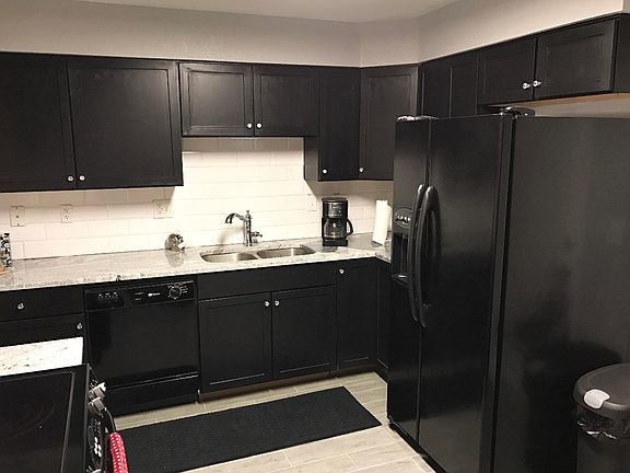 Kitchen with new granite countertops, backsplash, and tile floors.