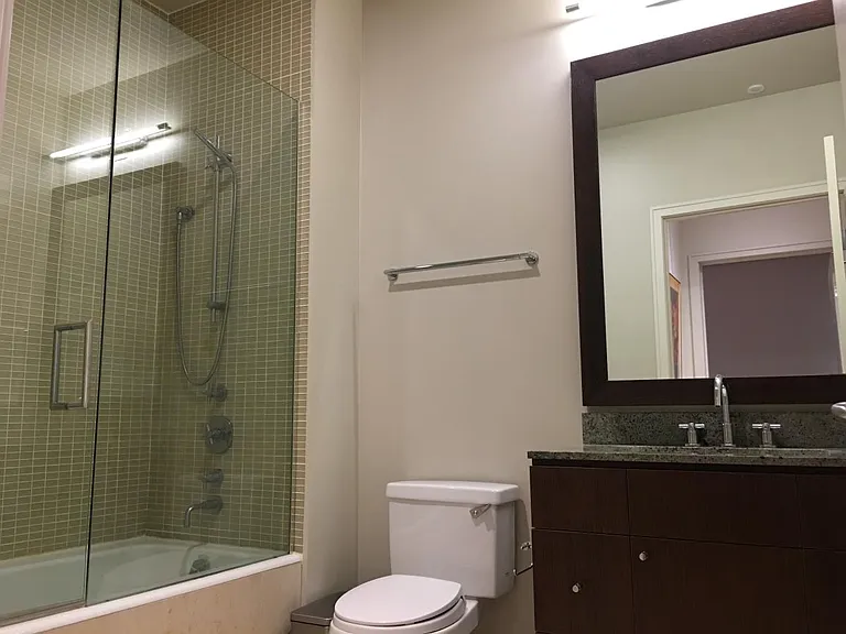 Natural limestone-tiled bathroom with soaking tub, Toto toil