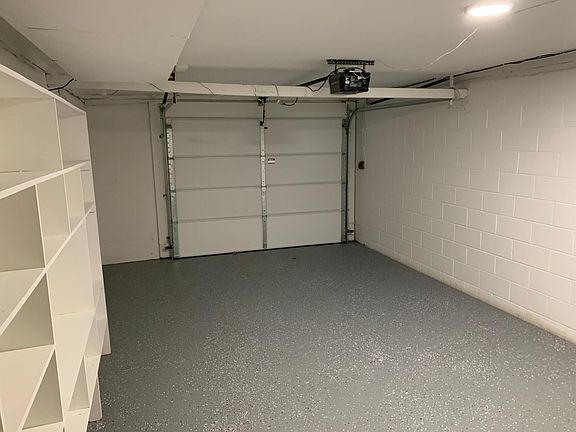 1 car garage with storage shelf